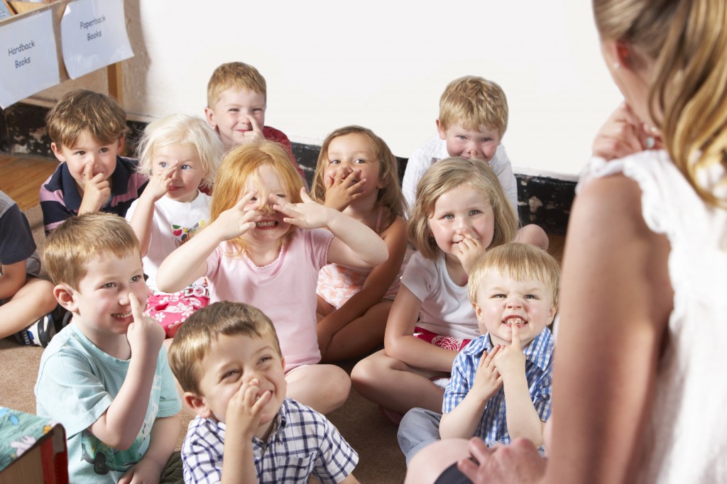 Montessori/Pre-School Class Listening to Teacher on Carpet