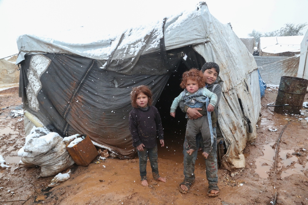 Niño refugiado durante una nevada en un campo de refugiados sirio cerca de la frontera turca. Alepo, Siria 14 de marzo de 2022