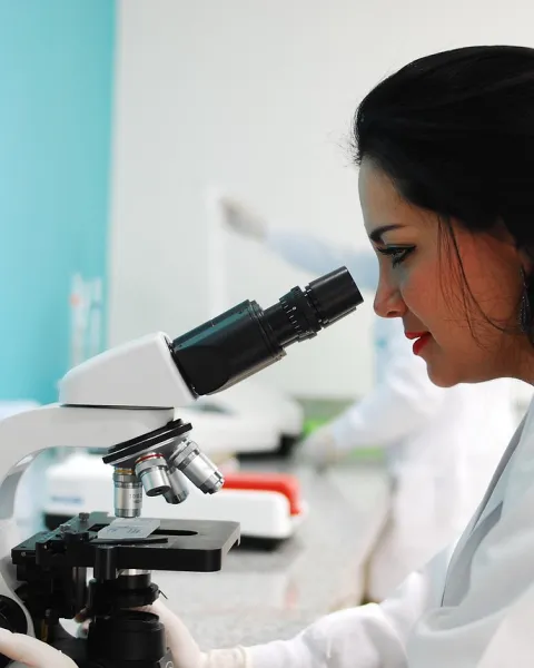 cientifica-en-un-laboratorio-mirando-por-un-microscopio-llevando-a-cabo-una-observacion-no-participante